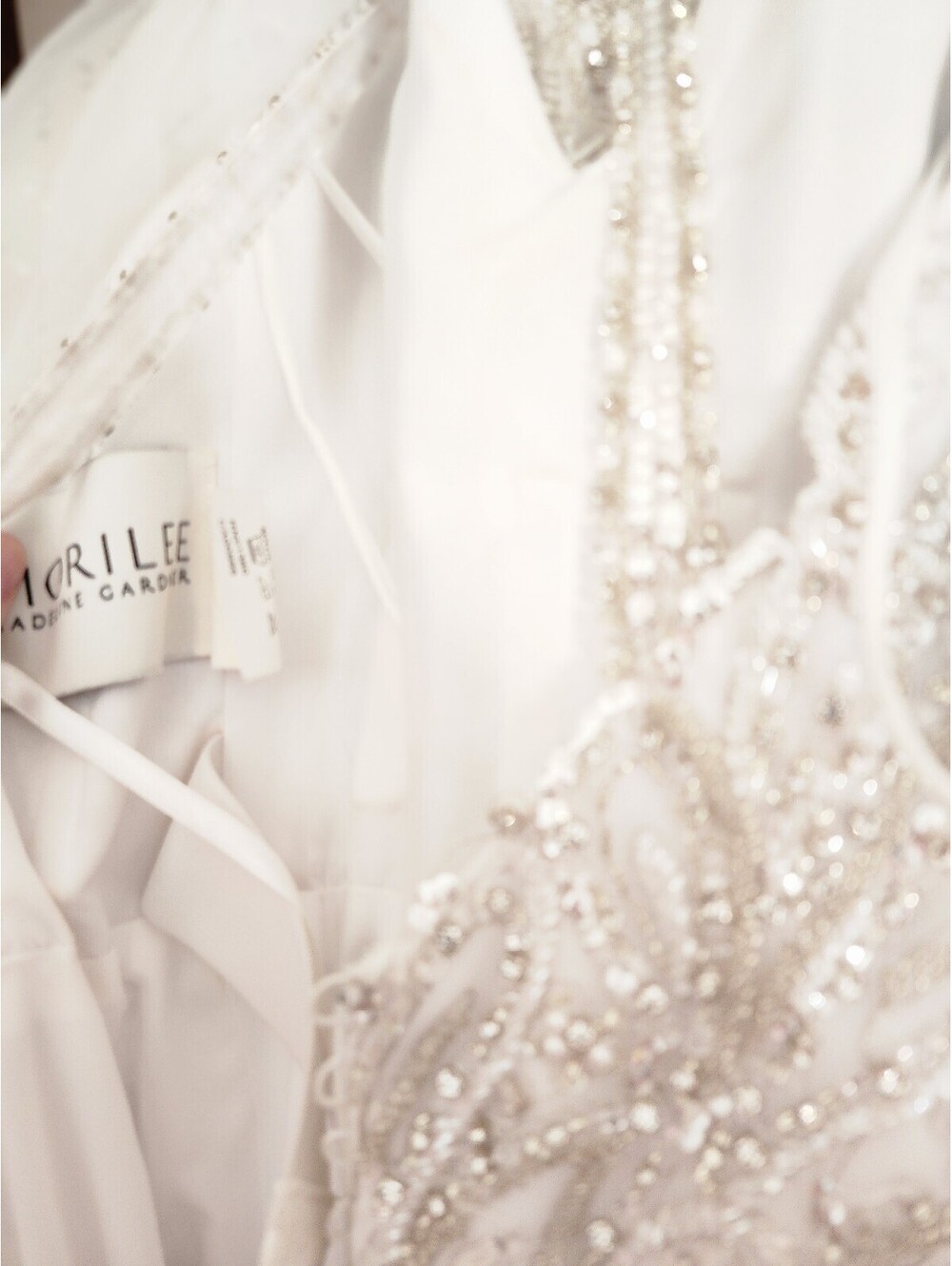 Elegant White Beaded Evening Gown with Sheer Embellished Bodice and Flowing Skit - Picture 8 of 9
